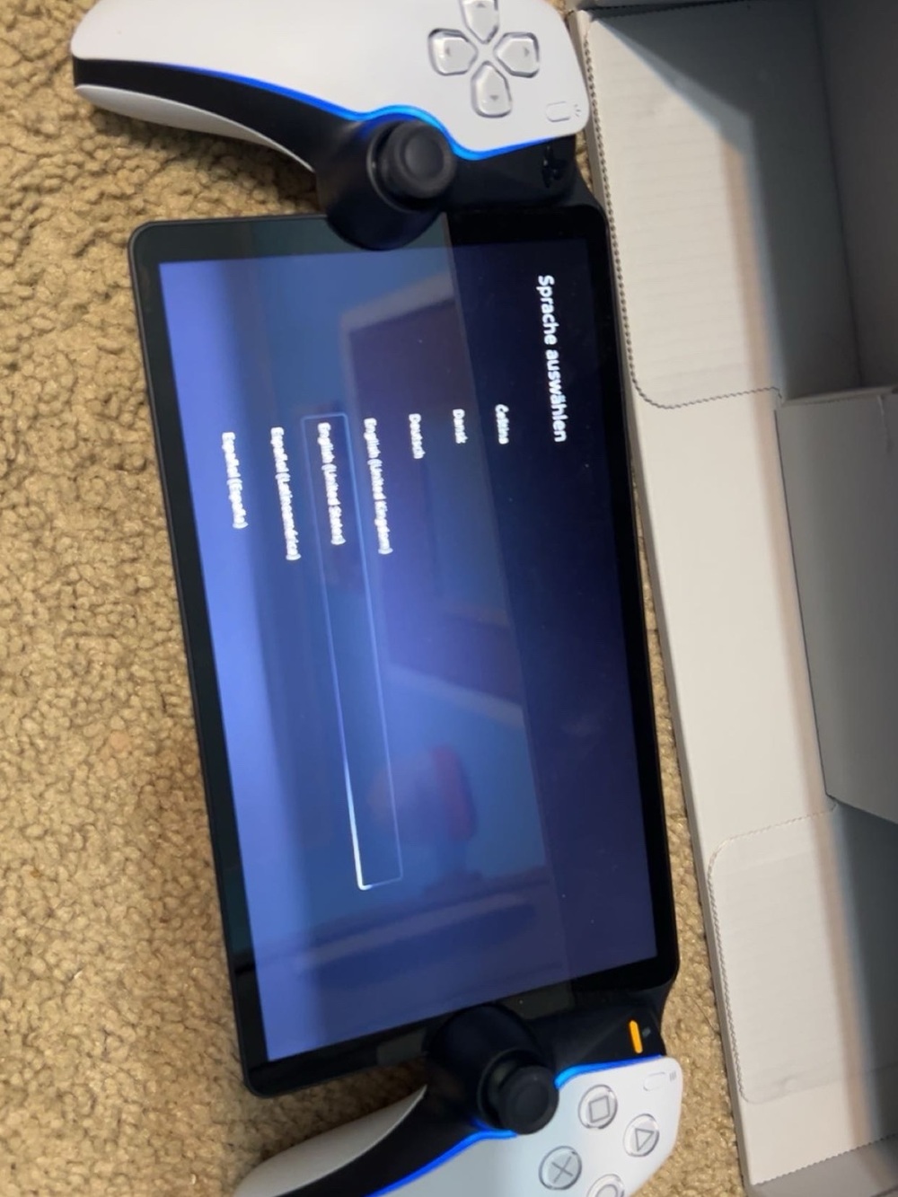 Sony Portable Gaming Screen with White/Black Controllers and Blue LEDs